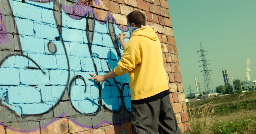 Photo of a Boy Doing Wall Graffitti