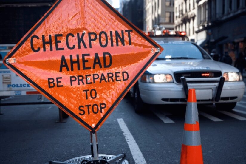 Checkpoint Ahead Sign And A Police Car