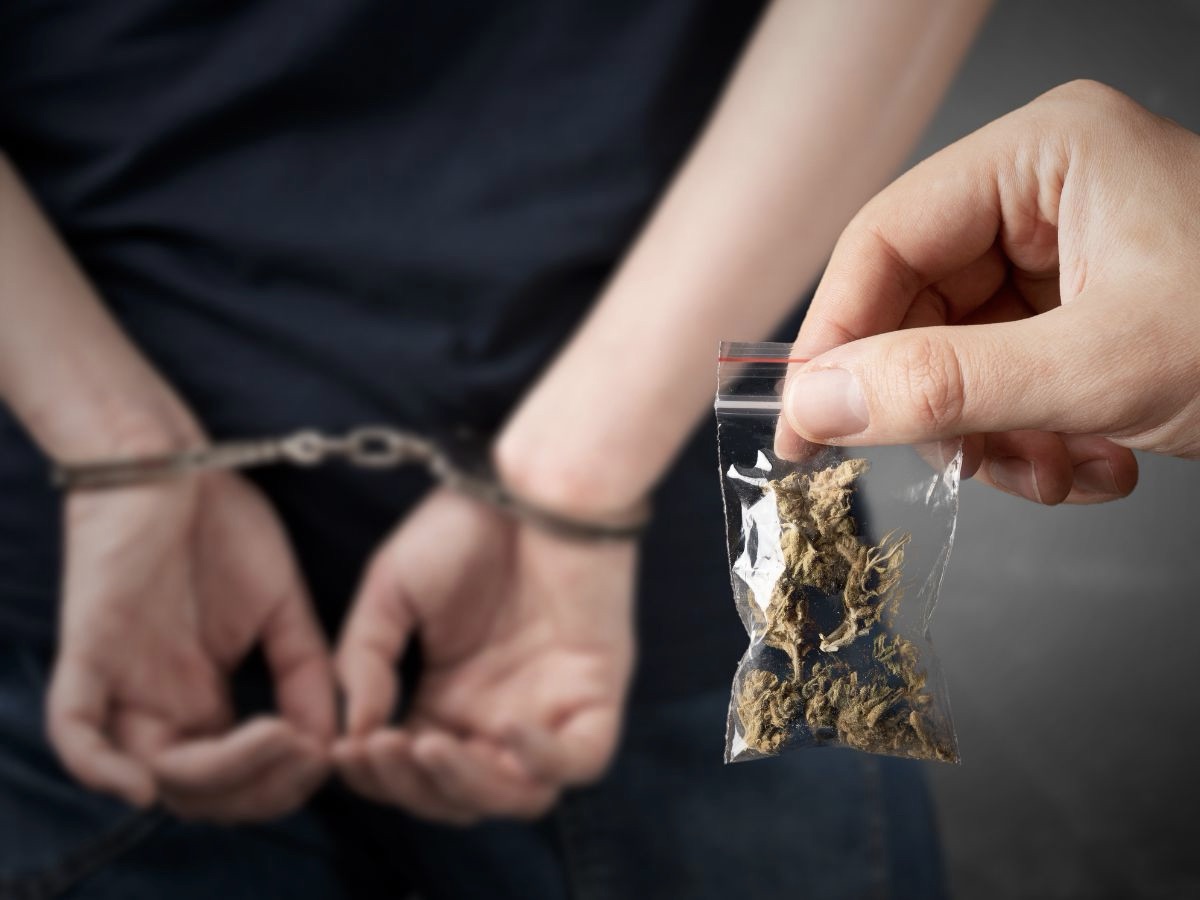 Marijuana Charge Marijuana Bag With A Handcuffed Person in the Background