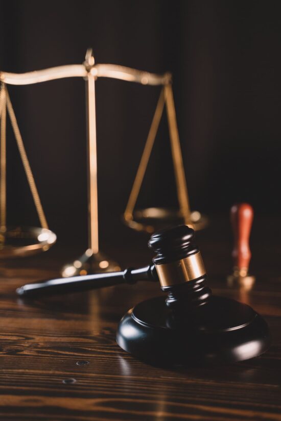 wooden gavel next to scales