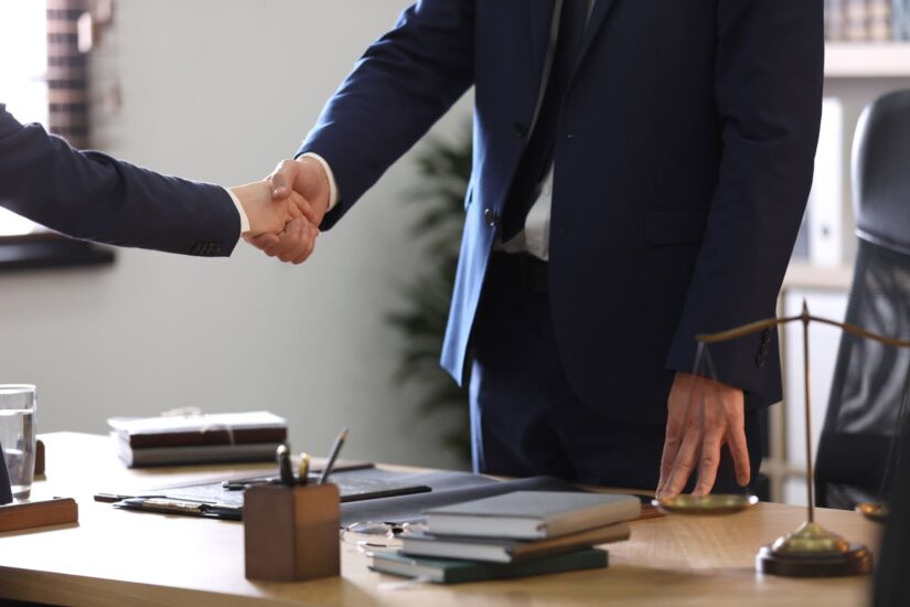 Attorney shakes client's hand