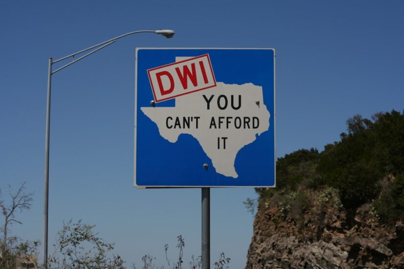 A road sign in Texas with the text: "DWI You Can't Afford It"