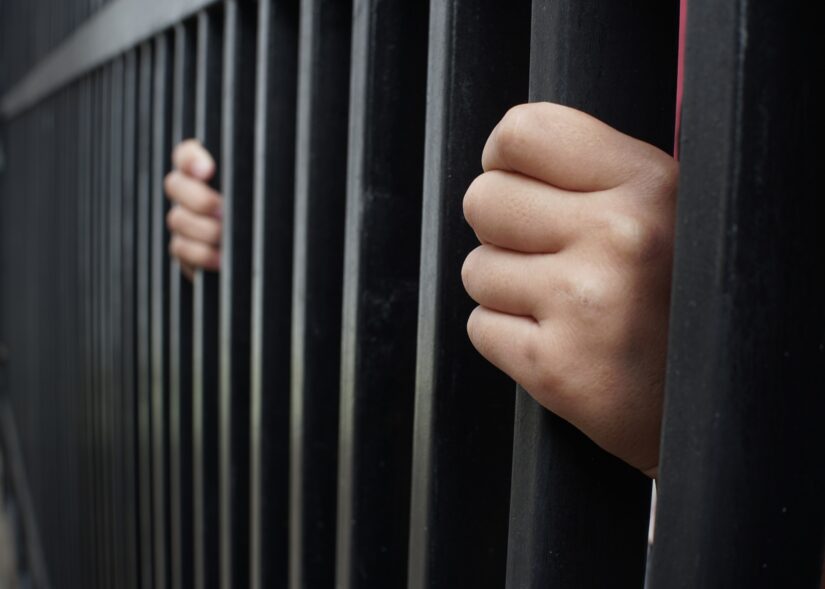 Prisoner Man behind prison bars