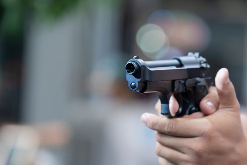 Person holding and aiming a pistol