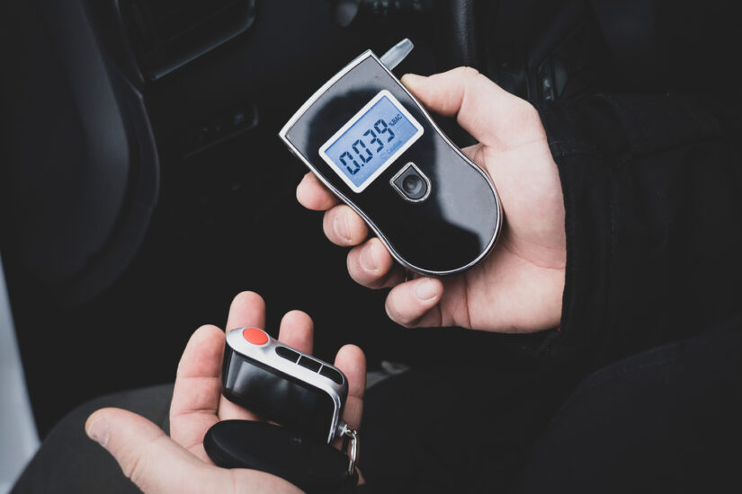 Person holding Breathalyzer